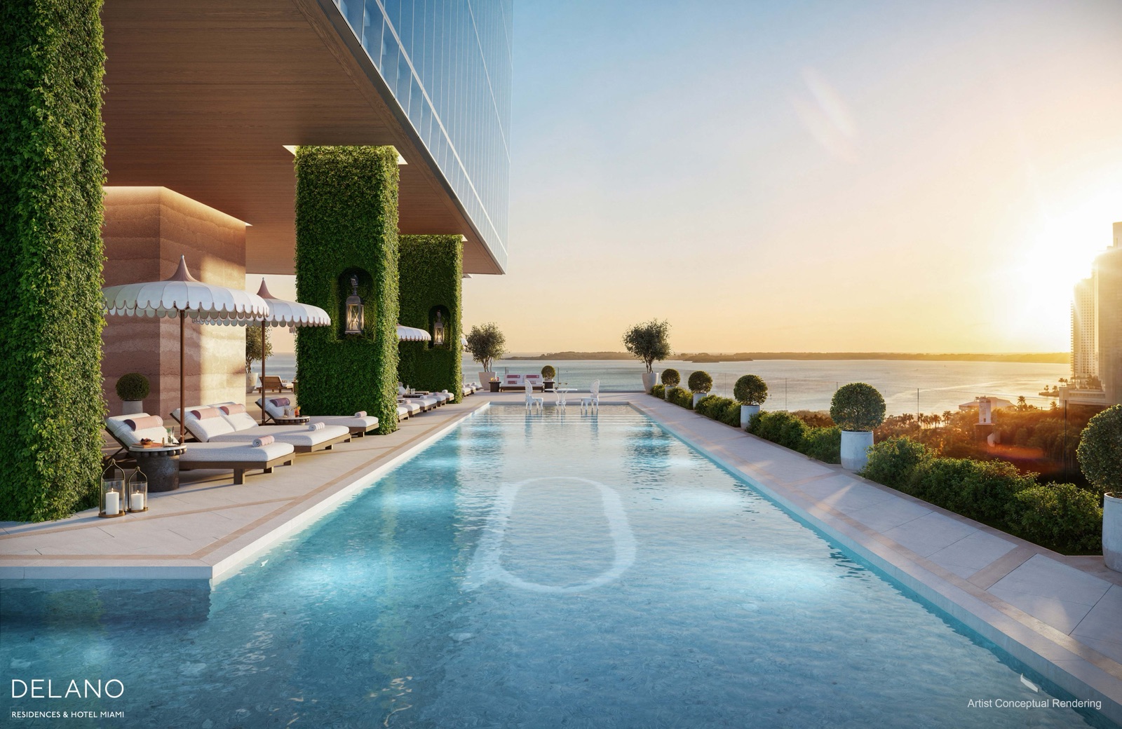 Resort-style pool deck with wrap-around pool, cabanas, and bar overlooking Biscayne Bay.